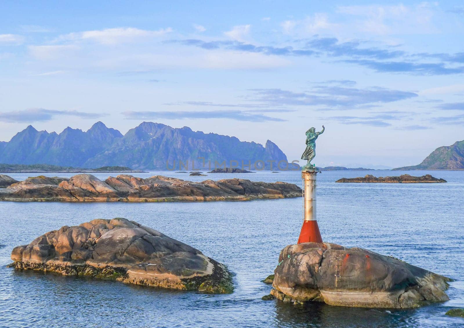 Svolvaer, Norway - July 7, 2009: View of the fiskarkona (the fishwife) sculpture at the entrance to Svolvaer harbor in Nordland County, Lofoten Islands, Norway.