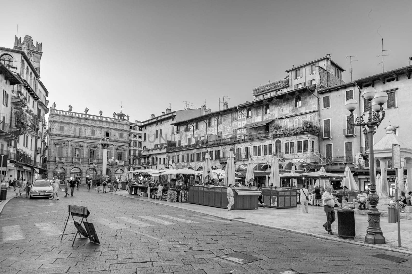 Verona, Italy - August 4, 2009:  people visit the old medieval town of Verona in late afternoon in summer time.