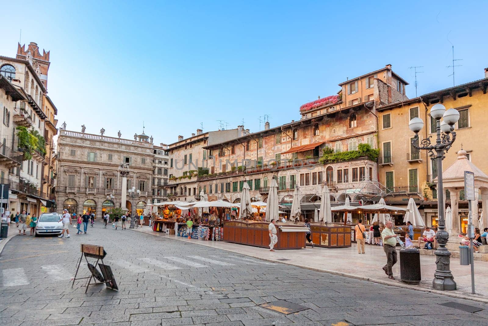 Verona, Italy - August 4, 2009:  people visit the old medieval town of Verona in late afternoon in summer time.