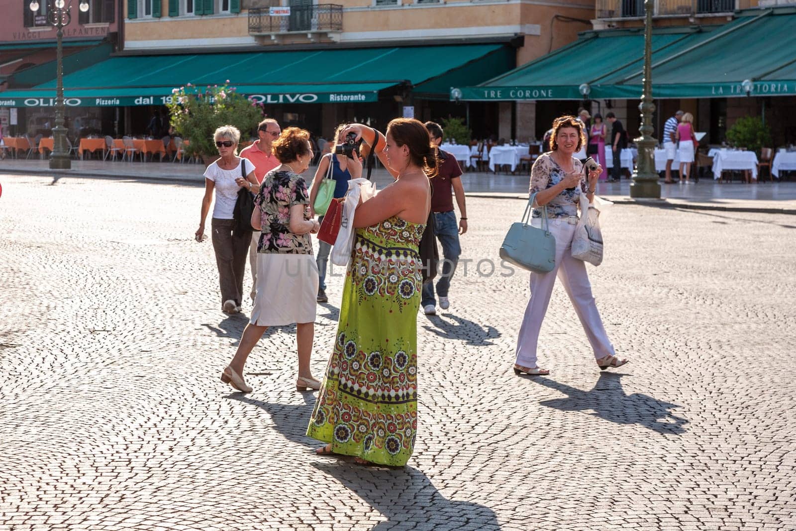 Verona, Italy - August 5, 2009: people enjoy taking photos at piazza Bra in Verona, Italy.