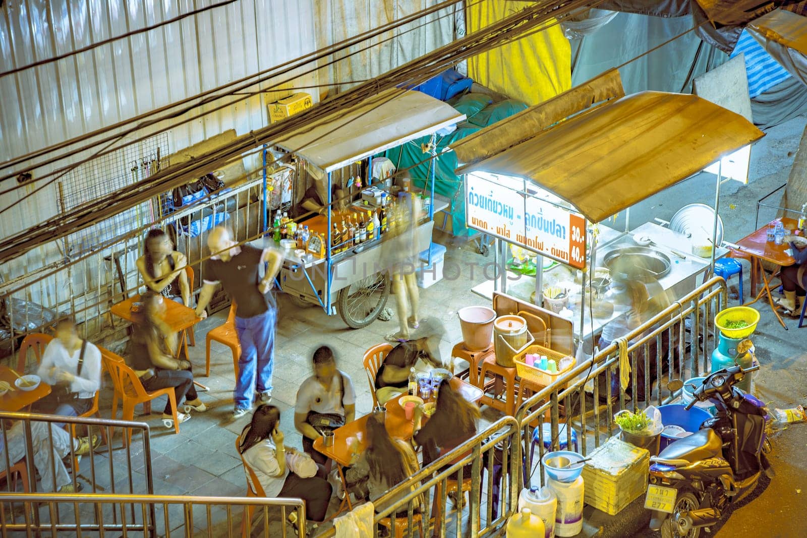Bangkok, Thailand - DEcember 21, 2009: food hawker at the night market along the street offer fresh warm food from the movable small kitchen