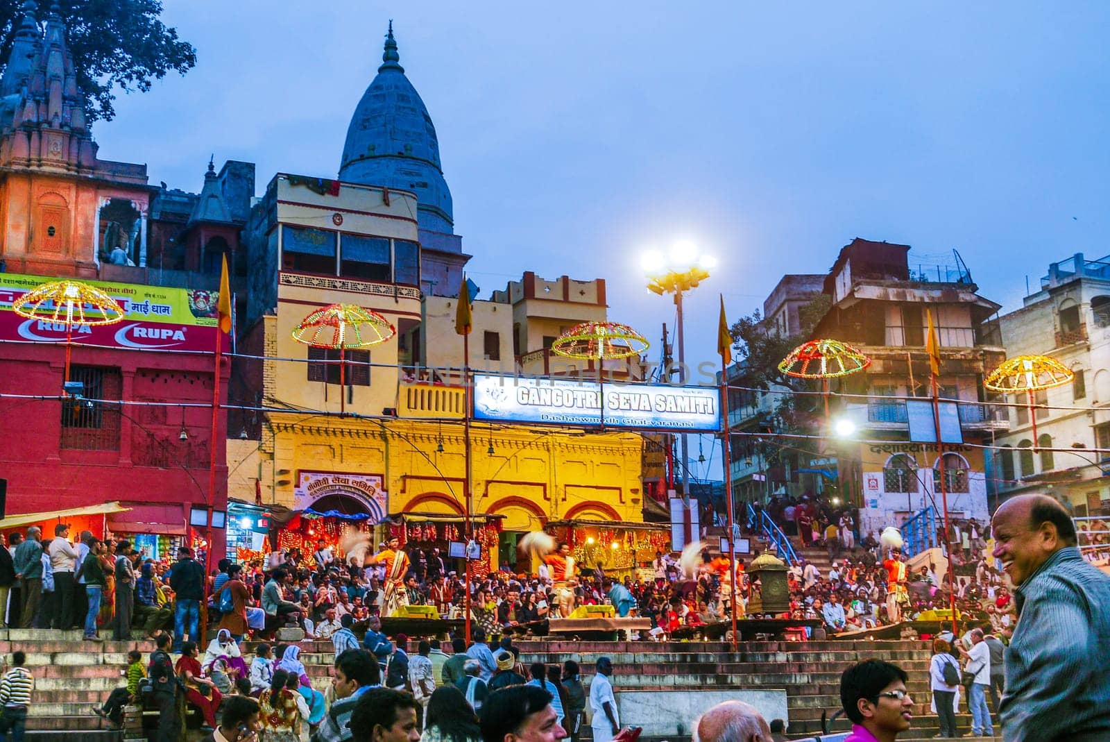 Varanasi, India - December 10, 2009: Hindu people celebrate at Dashaswmedh ghat at river Ganga in the holy city of Varanasi. The holy ritual of washing is held every day in Varanasi, India.