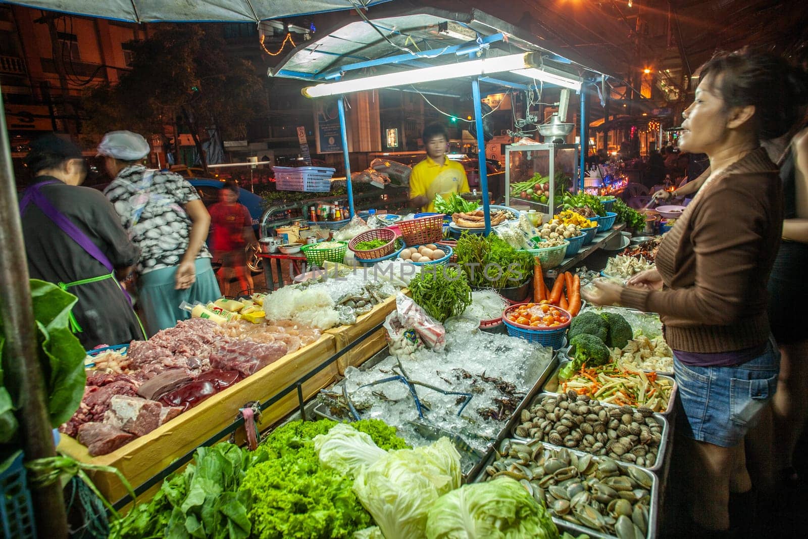 Bangkok, Thailand - DEcember 21, 2009: food hawker at the night market along the street offer fresh warm food from the movable small kitchen