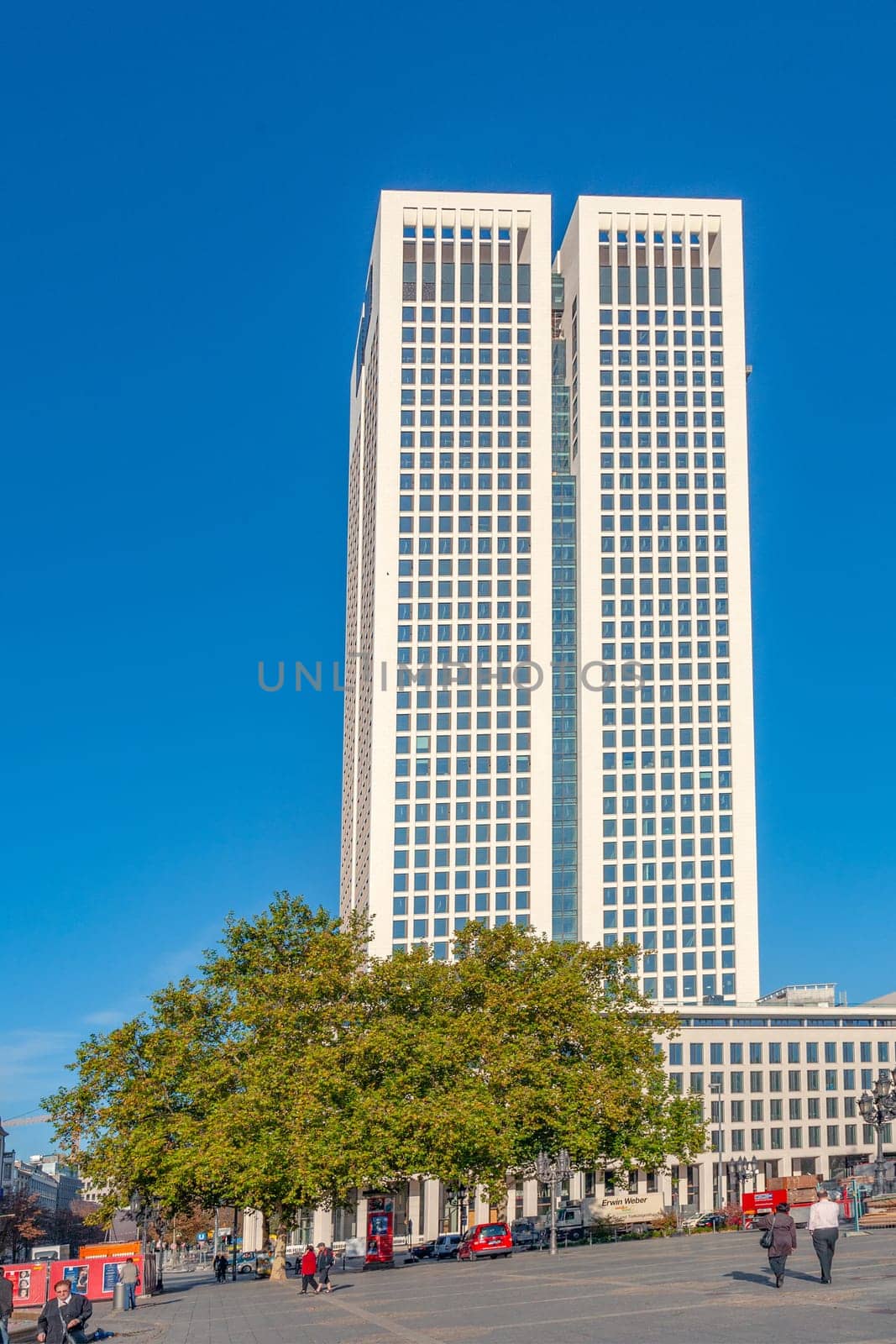 Frankfurt, Germany - October 9, 2009: view to modern skyscraper  in Frankfurt with people at town square.