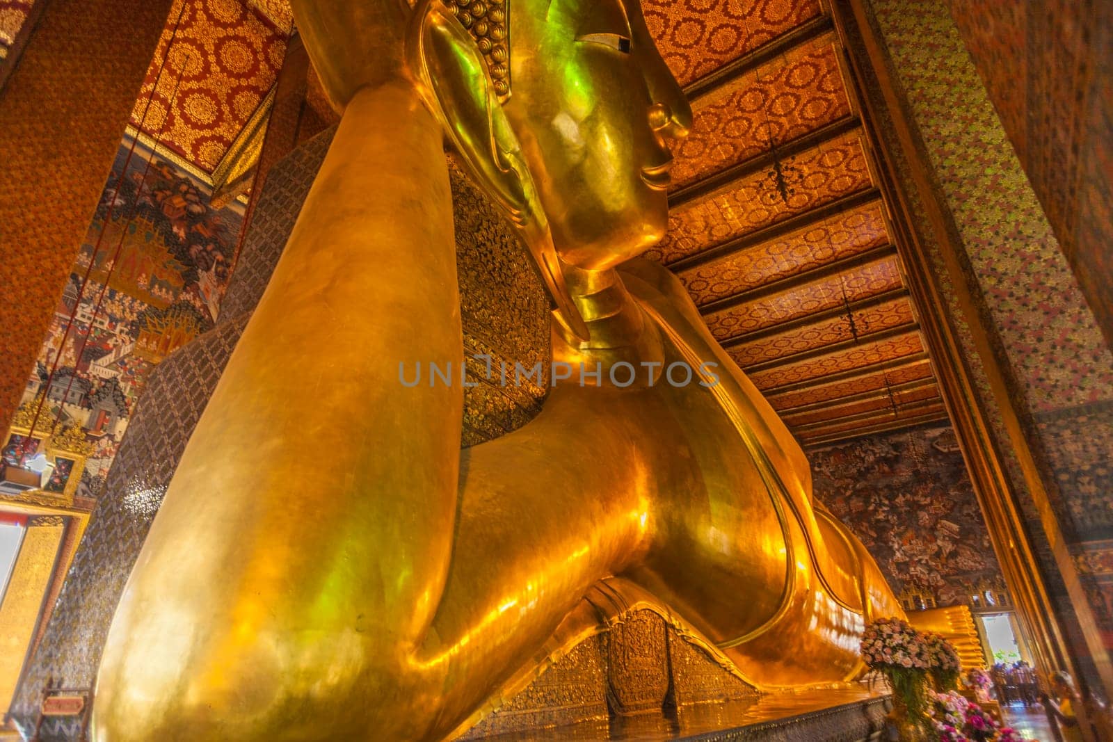 Bangkok, Thailand - January 4, 2010: Detail of the Reclining Buddha statue in temple Wat Pho in Bangkok, Thailand. Statue is 15 m high and 43 m long with his right arm supporting head.