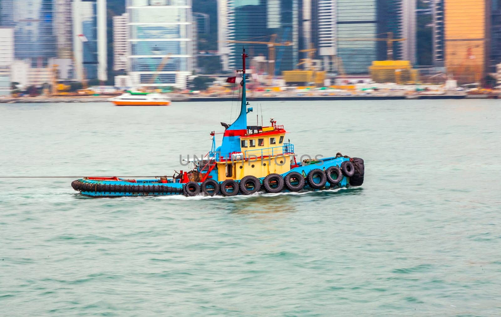 Victoria, Hongkong - January 8, 2010: tug boat cruising Victoria harbor