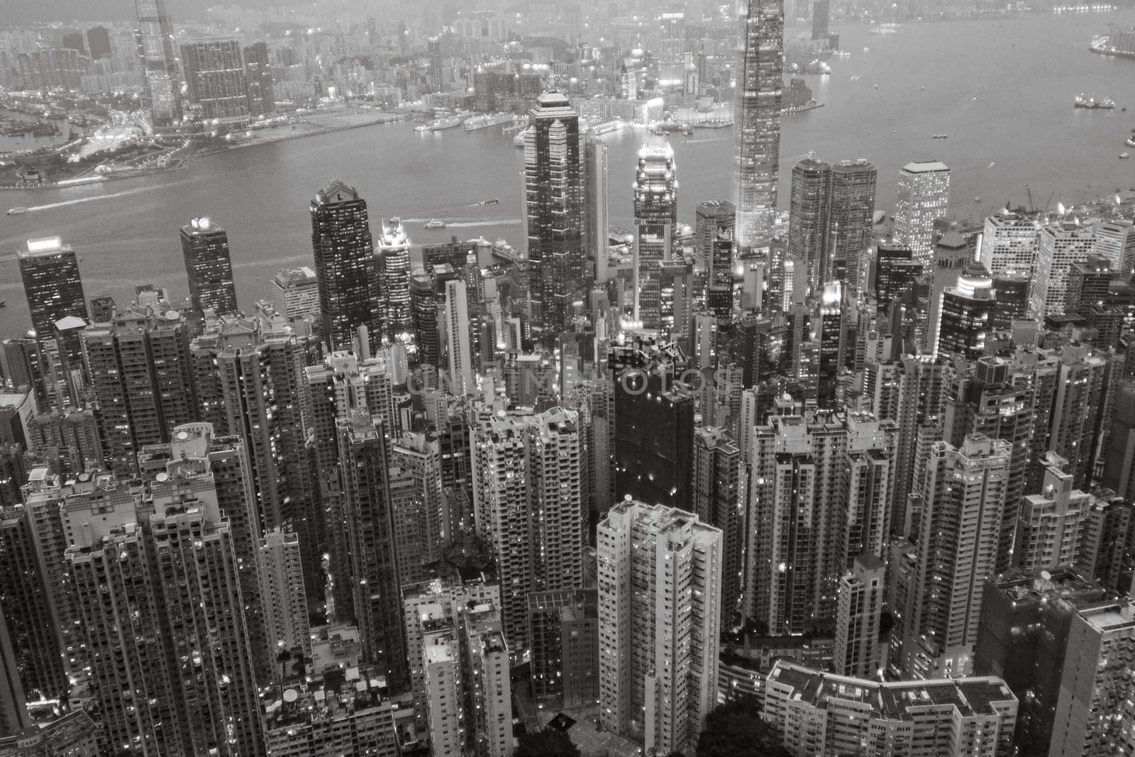 Victoria, Hong Kong - January 8, 2010: view by night from Victoria peak to the skyline and harbor of Hong Kong with spectacular skyscraper scene.
