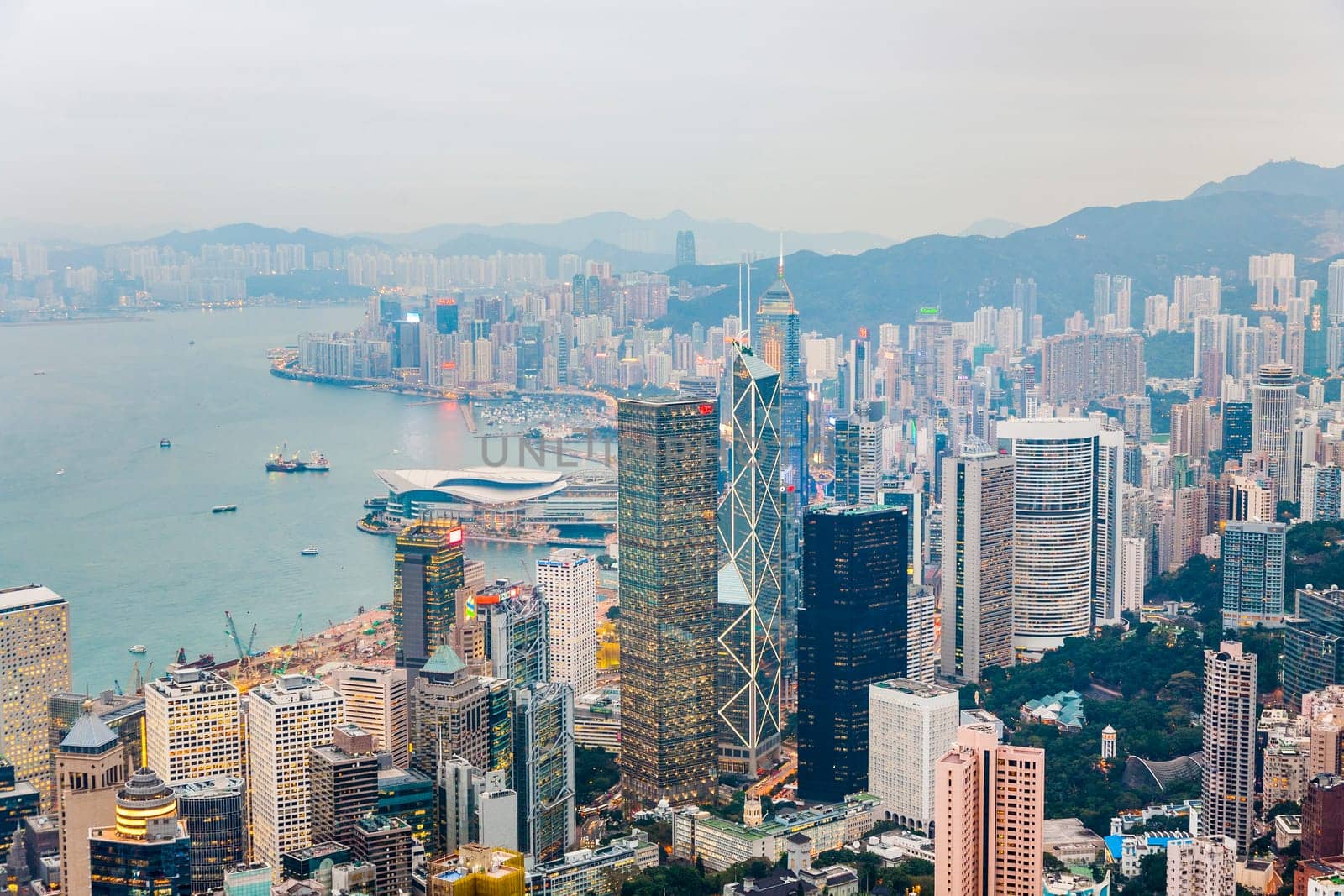 Kowloon, Hongkong - January 5, 2010: Hong Kong view from Victoria Peak to the bay and the illuminated skyscraper  in the evening in Kowloon, Hong Kong.