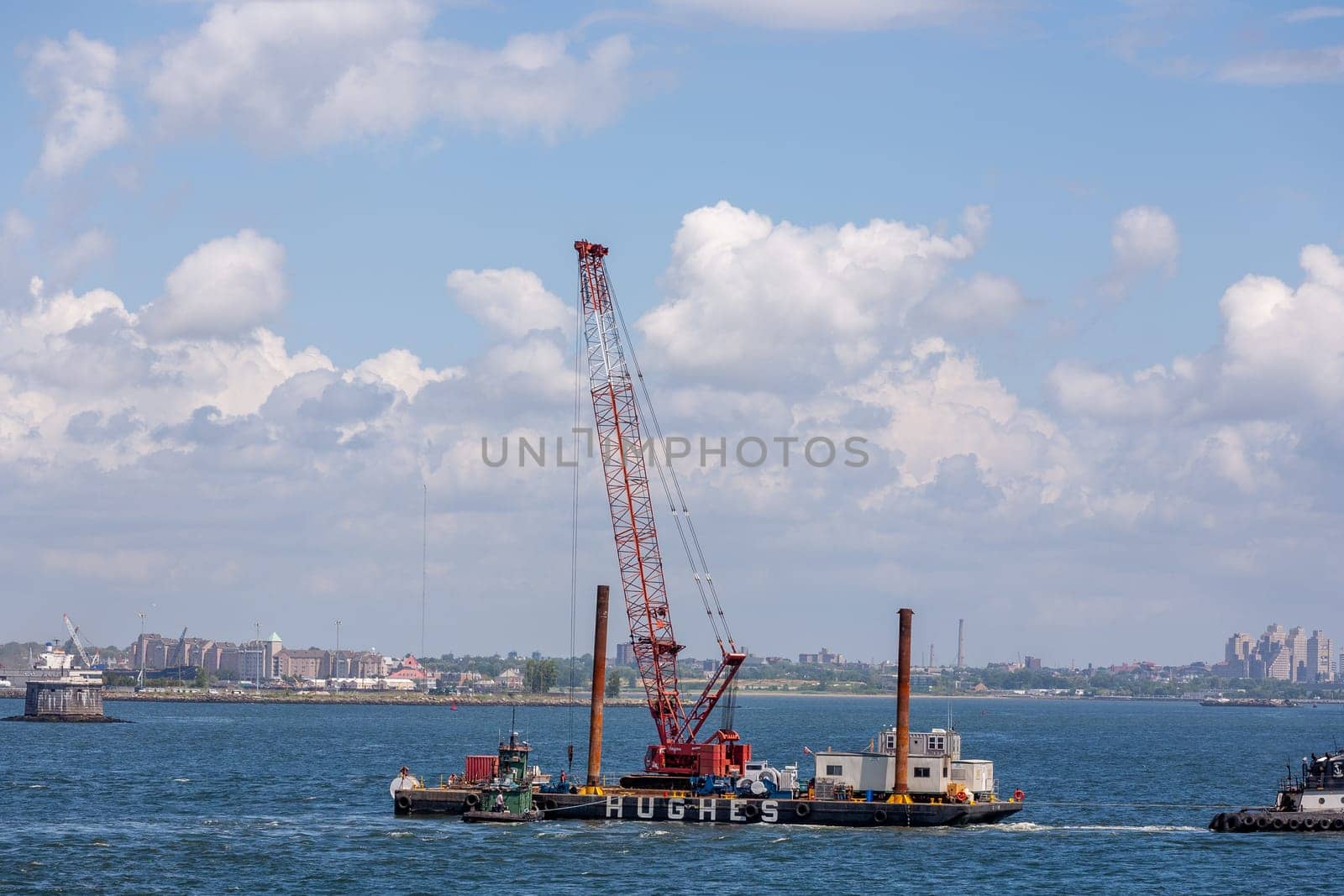 New York, USA - July 9, 2010: excavator ship Hudson at an offshore construction site installing iron pylons in the river bed of Hudson.