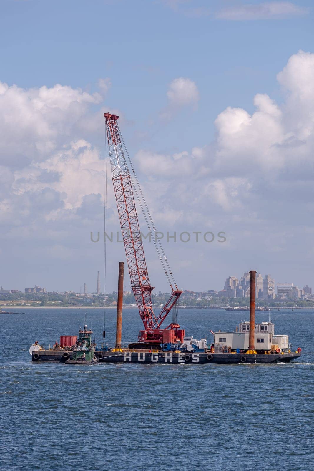 New York, USA - July 9, 2010: excavator ship Hudson at an offshore construction site installing iron pylons in the river bed of Hudson.