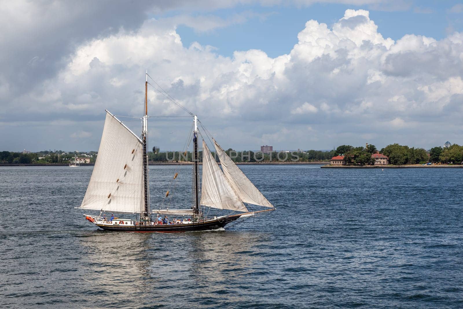 New York, USA - July 9, 2010: historic old sailing boat pioneer cruises at Ellis island in New York at river Hudson.