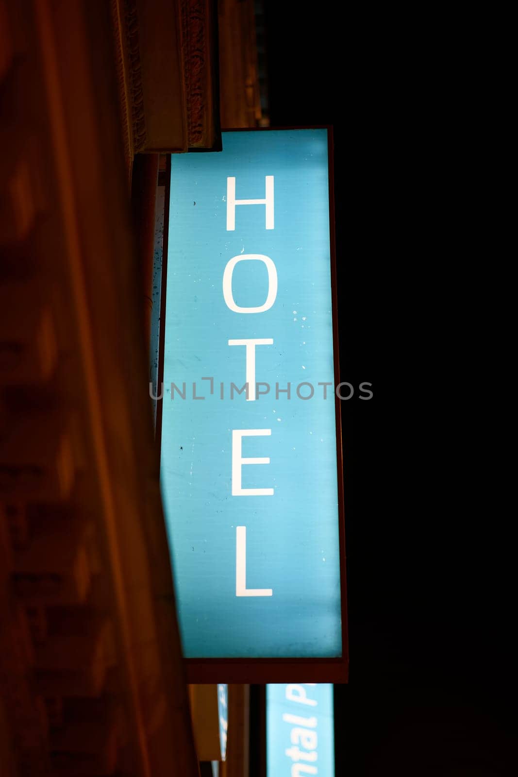 Illuminated sign of a hotel in the city center of Prague in the late evening