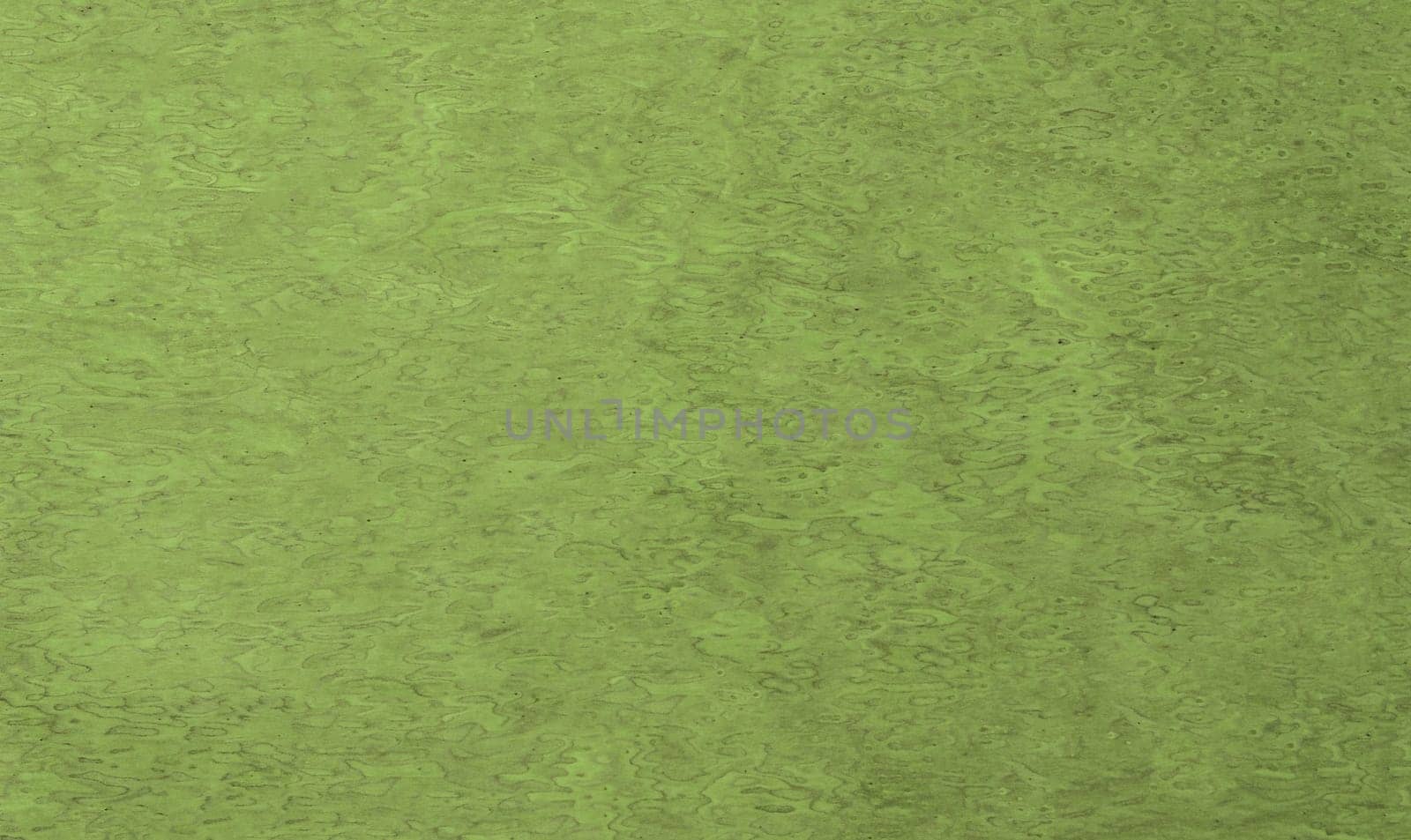 Abstract matte background of green and black colors with streaks on the surface in close-up.Texture or background