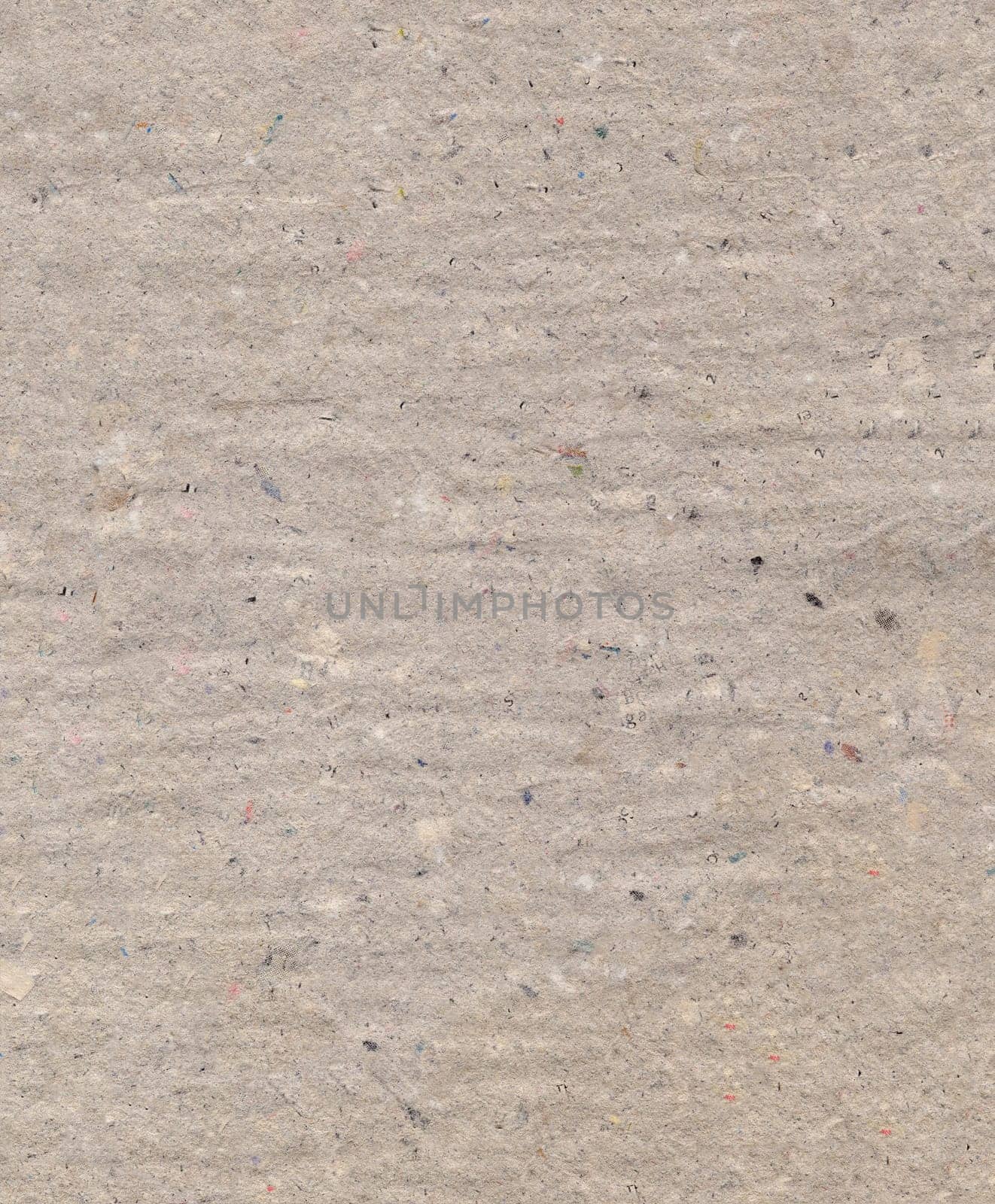 Pressed uneven dense gray cardboard with debris particles