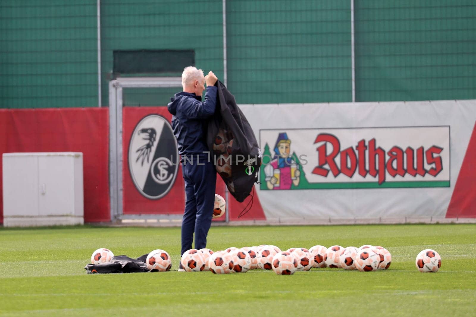 Coach Christian Streich (SC Freiburg) pours out a bag of balls before training at the final training session before the Europa League - Qualification 1/8 Final,SC Freiburg vs RC Lens