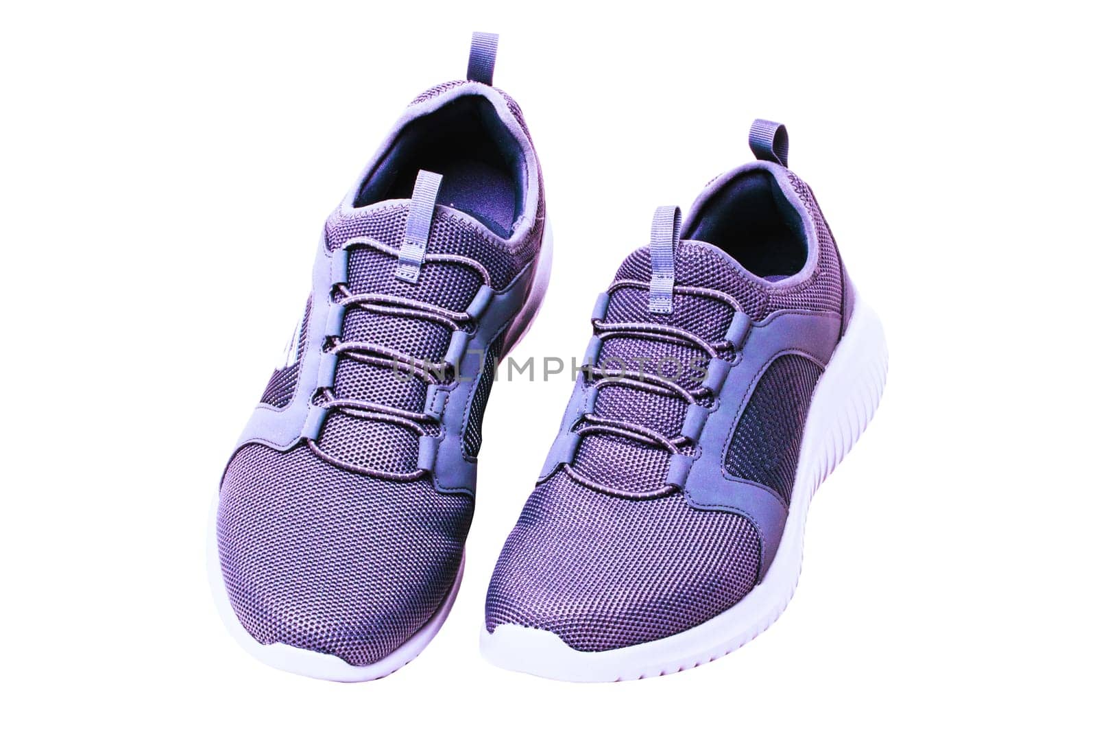 Closeup of a pair of modern silver gray sneakers or sports shoes isolated on a white background. Elegant and trendy mans shoes. Macro.