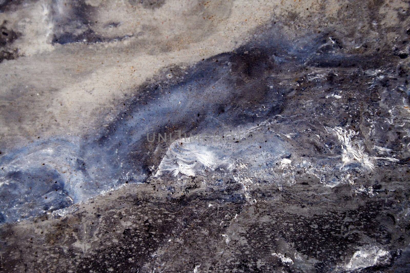 The background texture of an uneven stone surface in a blue-gray tone.Texture or background.View from above