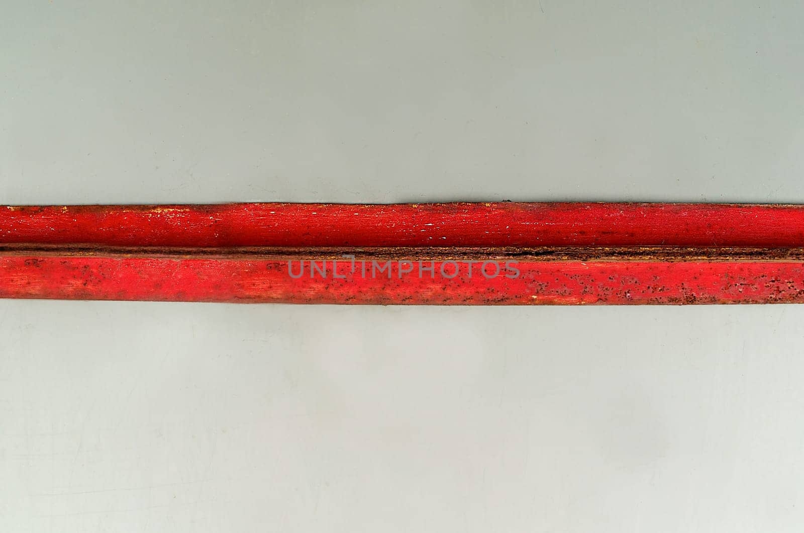 Background texture of a red horizontal rusty metal plate on a light background close-up view from above