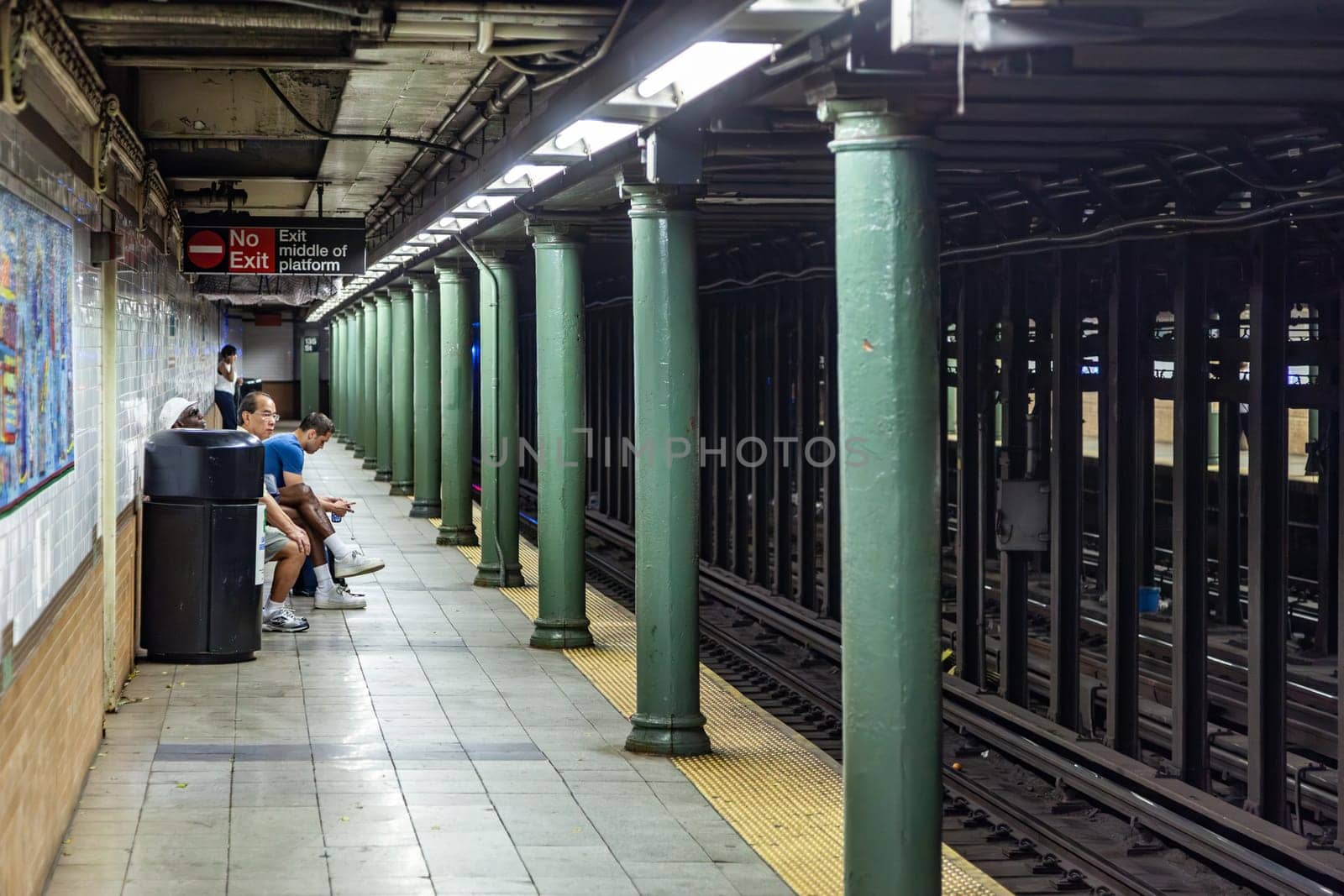 New York, USA - July 11, 2010:  people wait for the arriving train in New York metro.