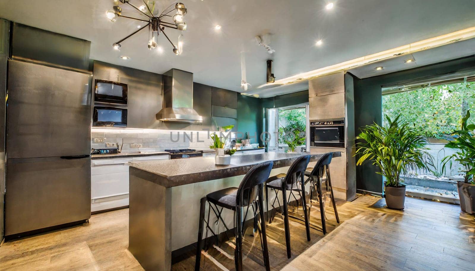 Cozy studio apartment with inviting interior featuring a comfortable brown sofa curtains and a cream colored kitchen with an island