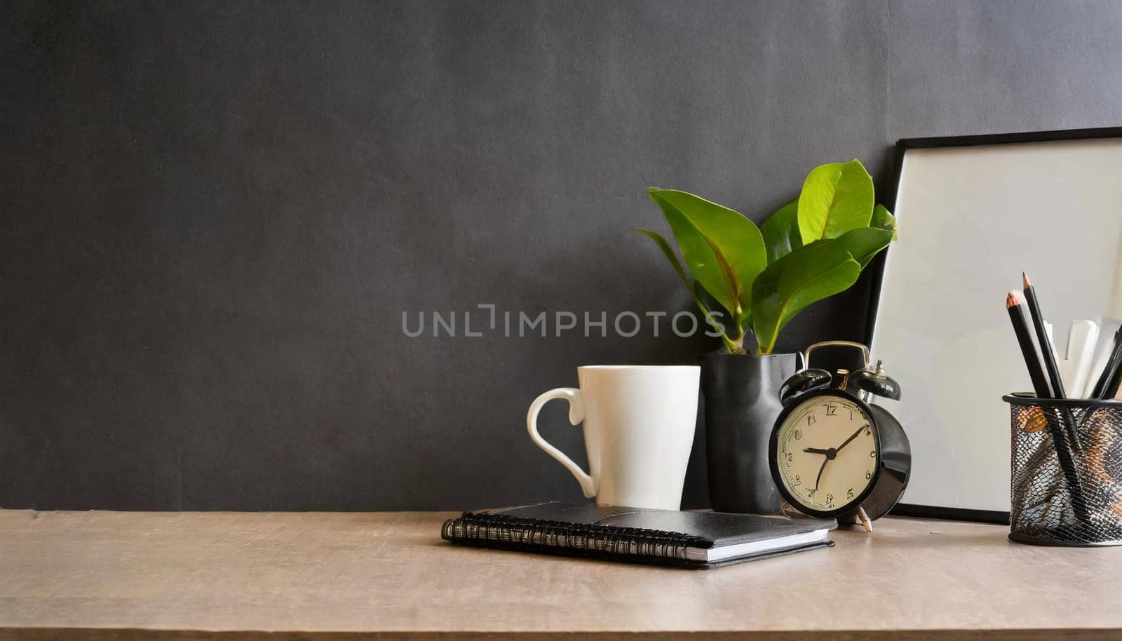 office table with copy space, stationery, vase, and lamp.