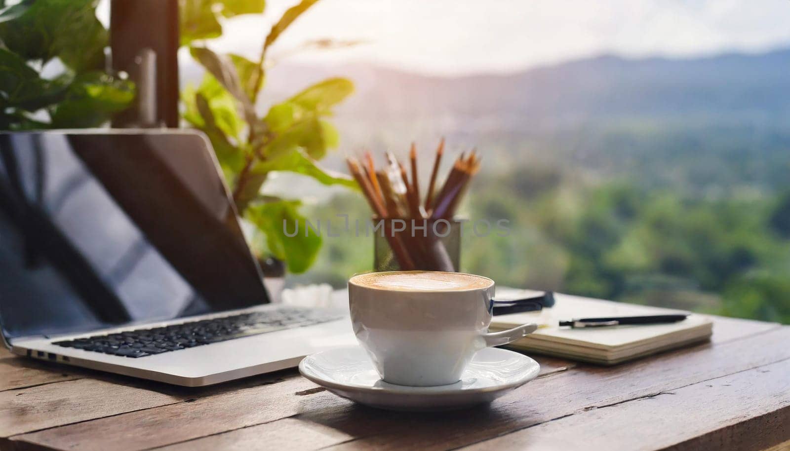 Modern workplace with laptop computer, coffee cup and office supplies