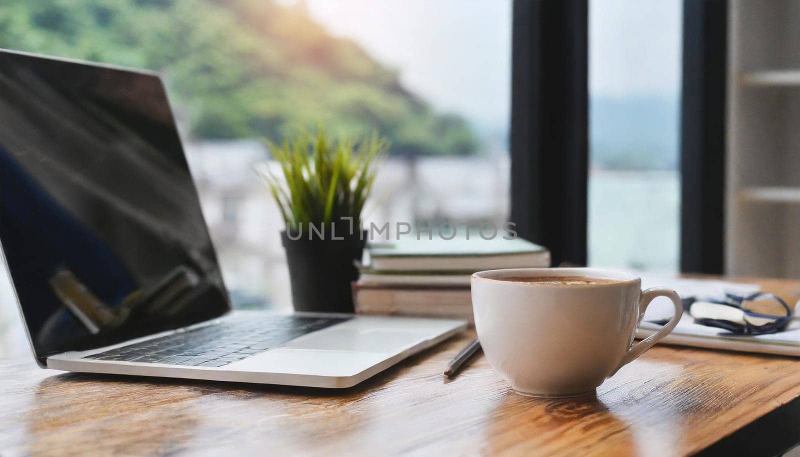 Modern workplace with laptop computer, coffee cup and office supplies