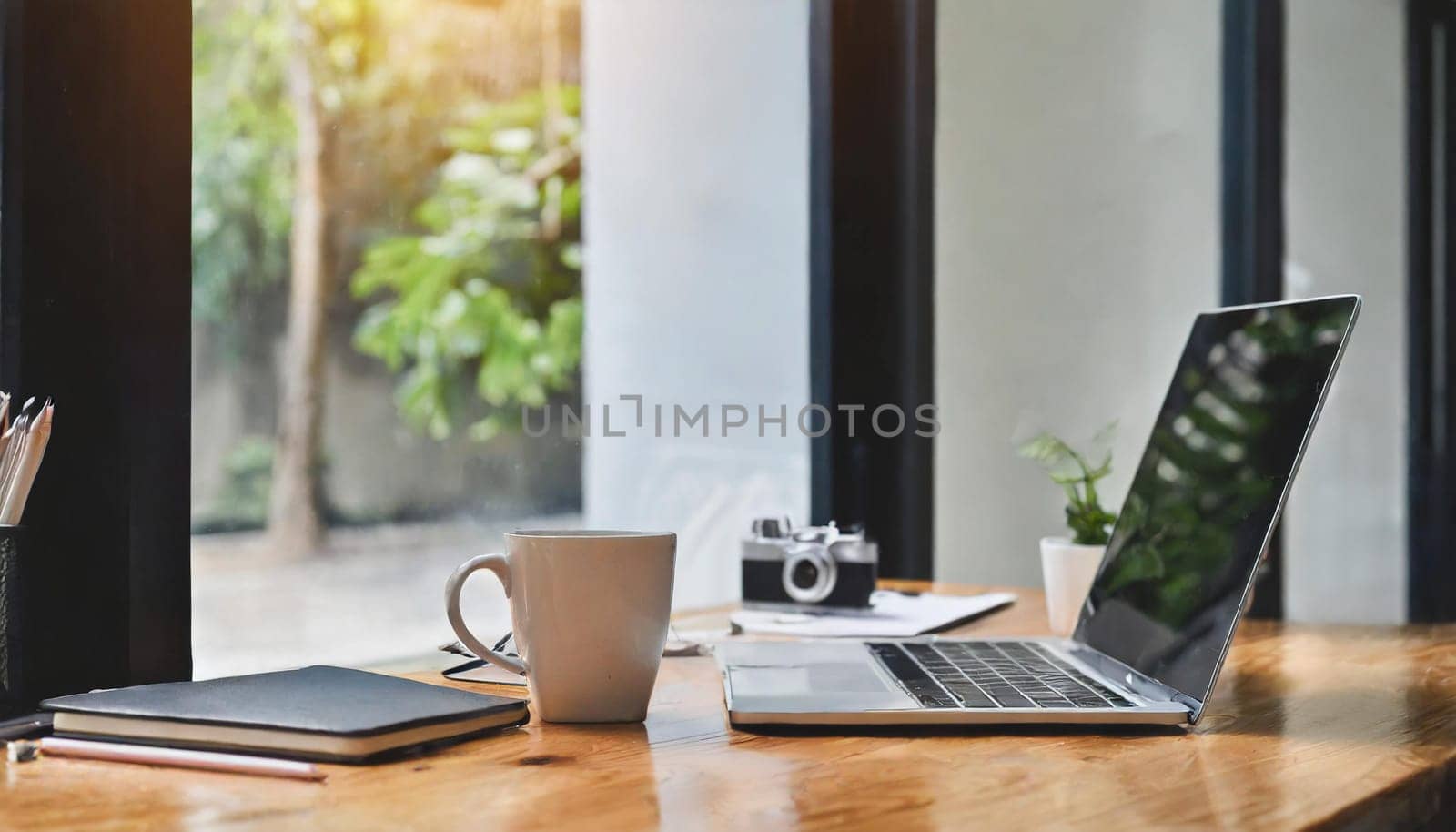 Modern workplace with laptop computer, coffee cup and office supplies