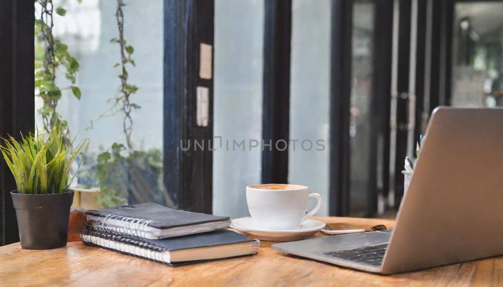 Modern workplace with laptop computer, coffee cup and office supplies