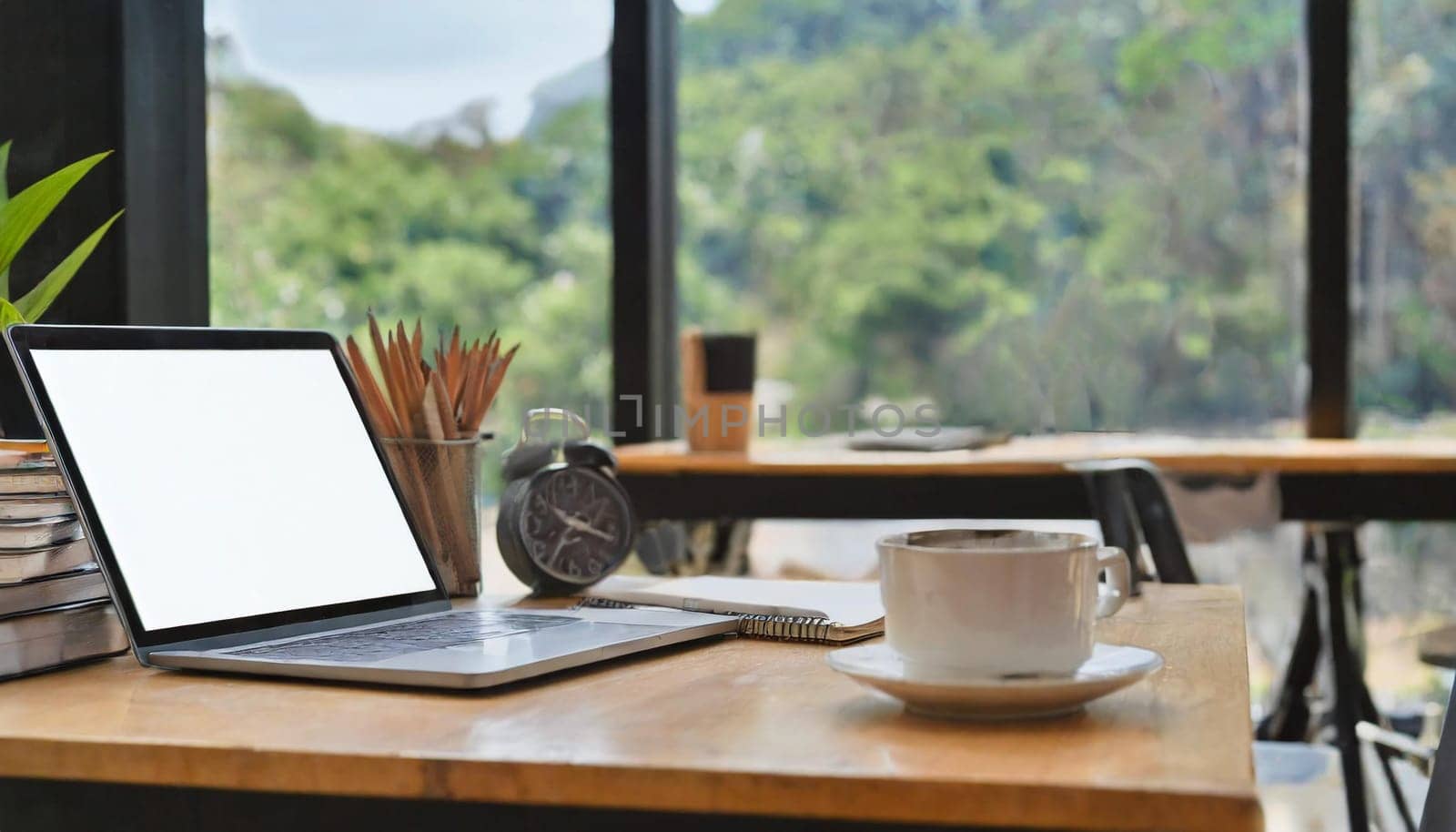 Modern workplace with laptop computer, coffee cup and office supplies