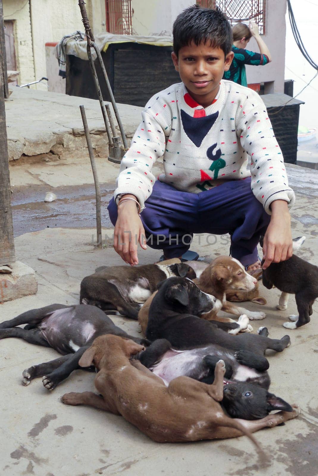 Varanasi, India - December 10, 2009: boy is selling young dogs in Varanasi, India. Dog meat is eaten in India.