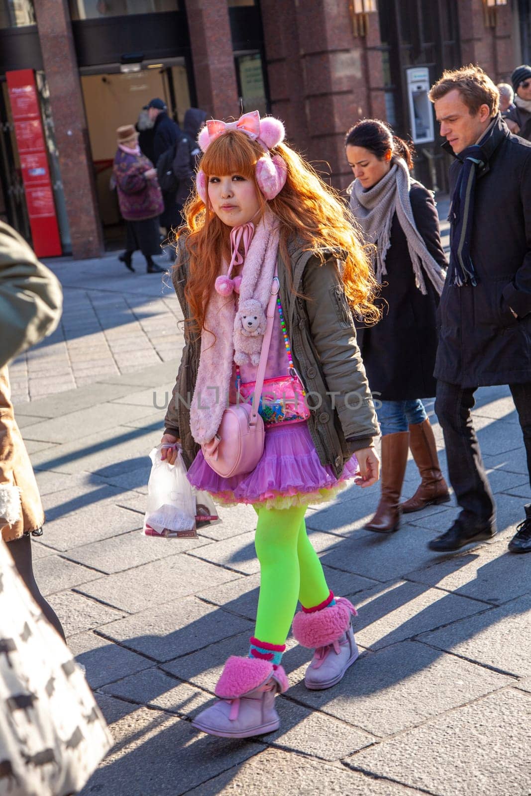 Vienna, Austria - November 27, 2010: japanese young woman dressed in a Manga colorful costume visits the st. stephens square in Vienna in winter time.