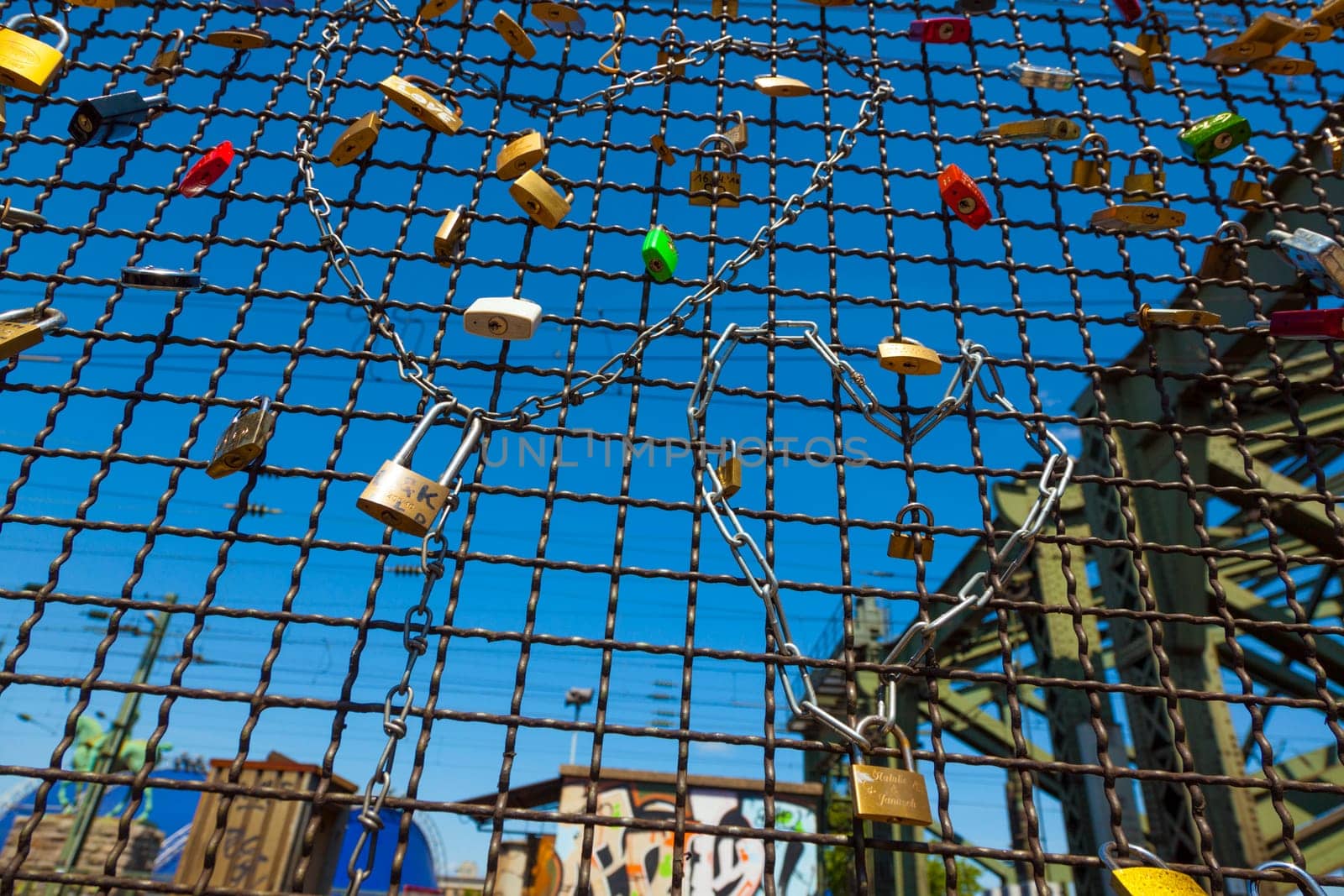 Cologne, Germany - May 29, 2011: lockers at the  Hohenzollern bridge symbolize love for ever in Cologne, Germany. It is the most heavily used railway bridge in Germany and used by pedestrians in love.