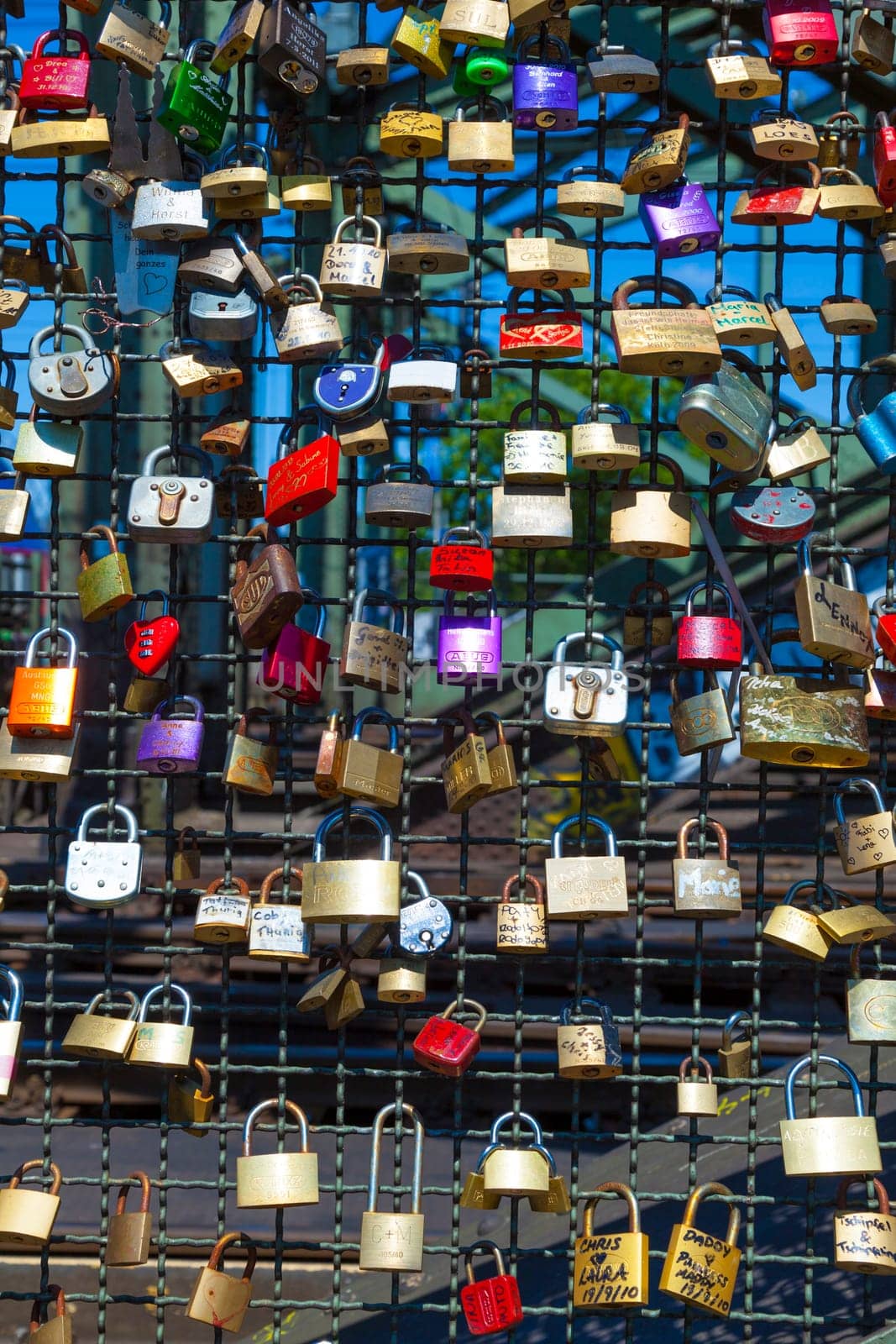 Cologne, Germany - May 29, 2011: lockers at the  Hohenzollern bridge symbolize love for ever in Cologne, Germany. It is the most heavily used railway bridge in Germany and used by pedestrians in love.