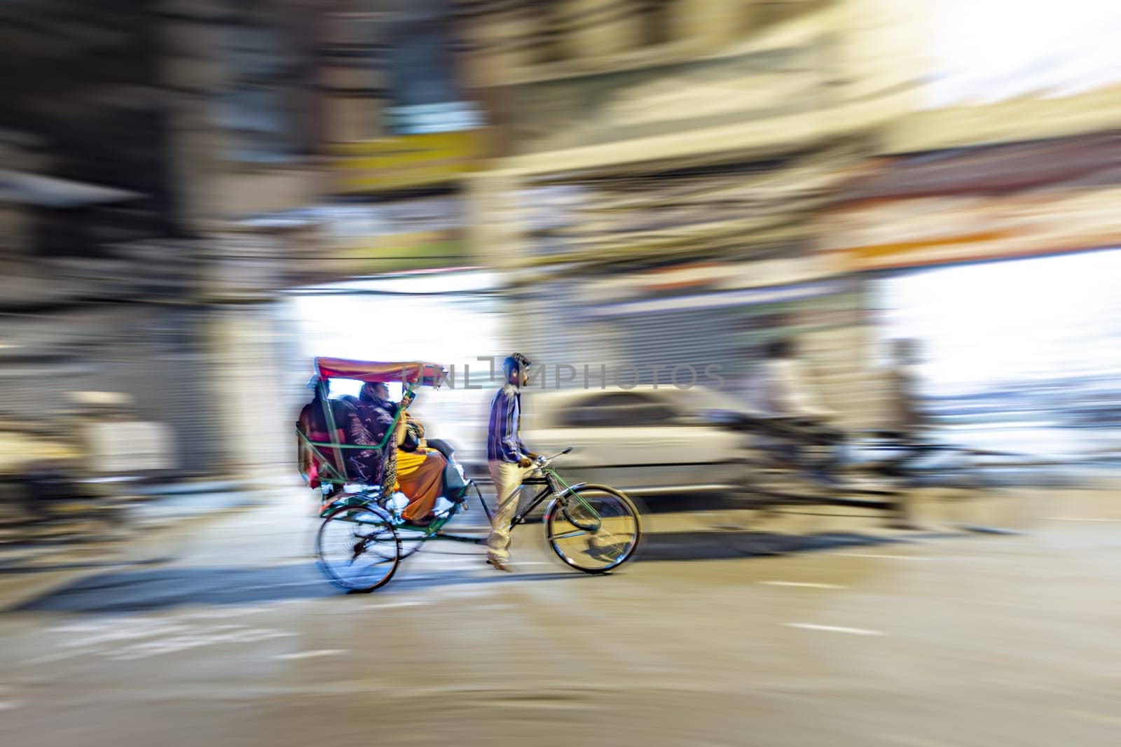 New Delhi, India - November 10, 2011:  rickshaw driving in blurred motion by night in Chandni Chowk. The Chandni Chowk is one of the oldest and busiest markets in Old Delhi, India.