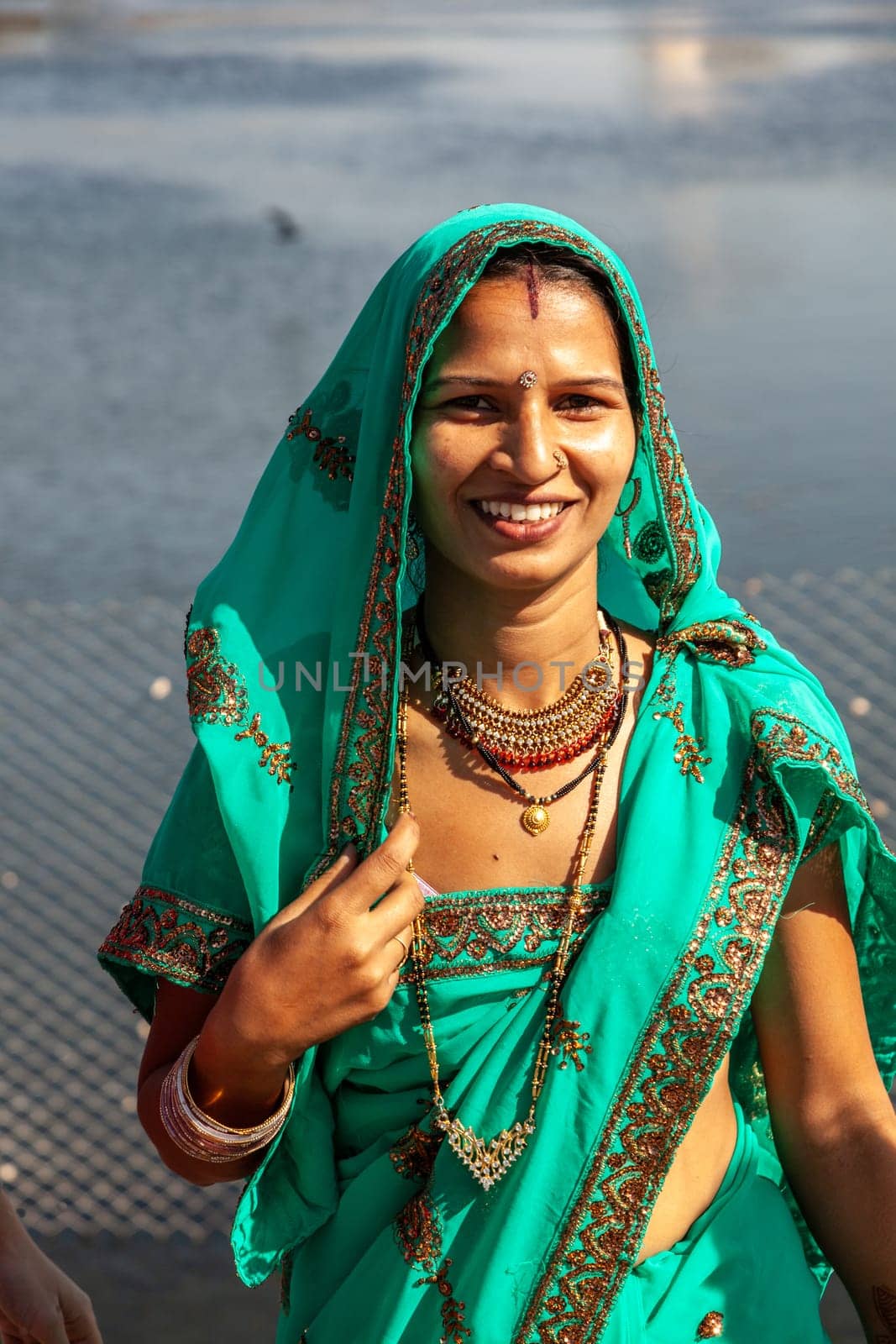 JAIPUR, INDIA - November 12, 2011: attractive indian woman in local sari, dressed for a festival enjoys posing for the photographer.