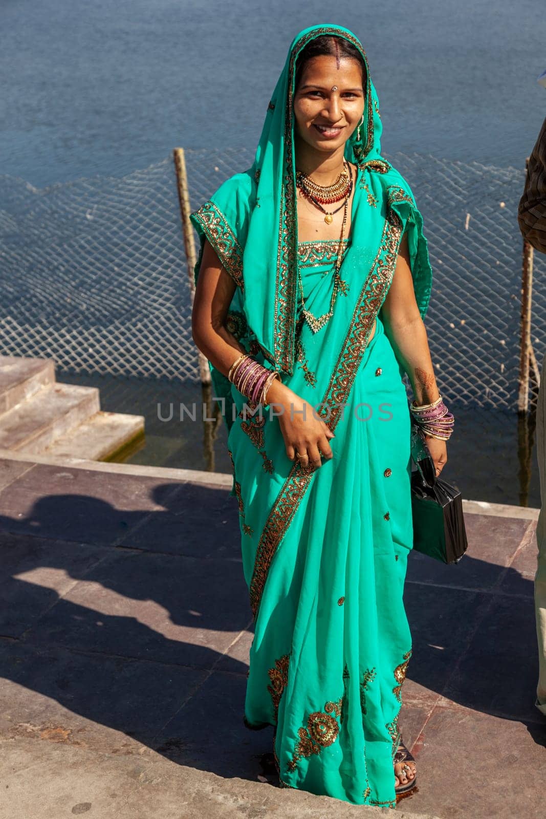 JAIPUR, INDIA - November 12, 2011: attractive indian woman in local sari, dressed for a festival enjoys posing for the photographer.