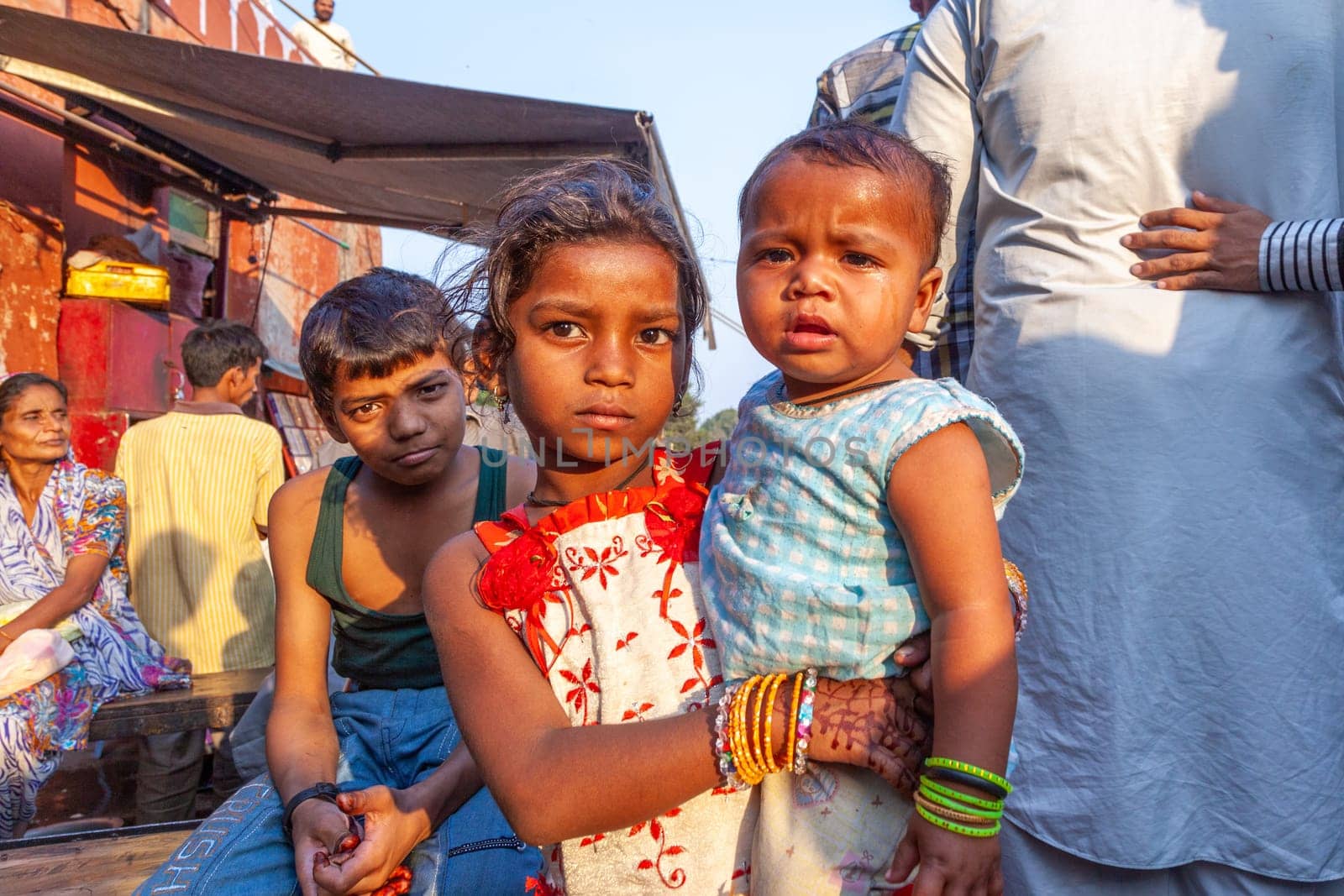 New Delhi, India - November 10, 2011:  portrait of young woman with child on arm  at  Meena Bazaar Market in Delhi, India. Shah Jahan founded the bazaar in the 17th century.