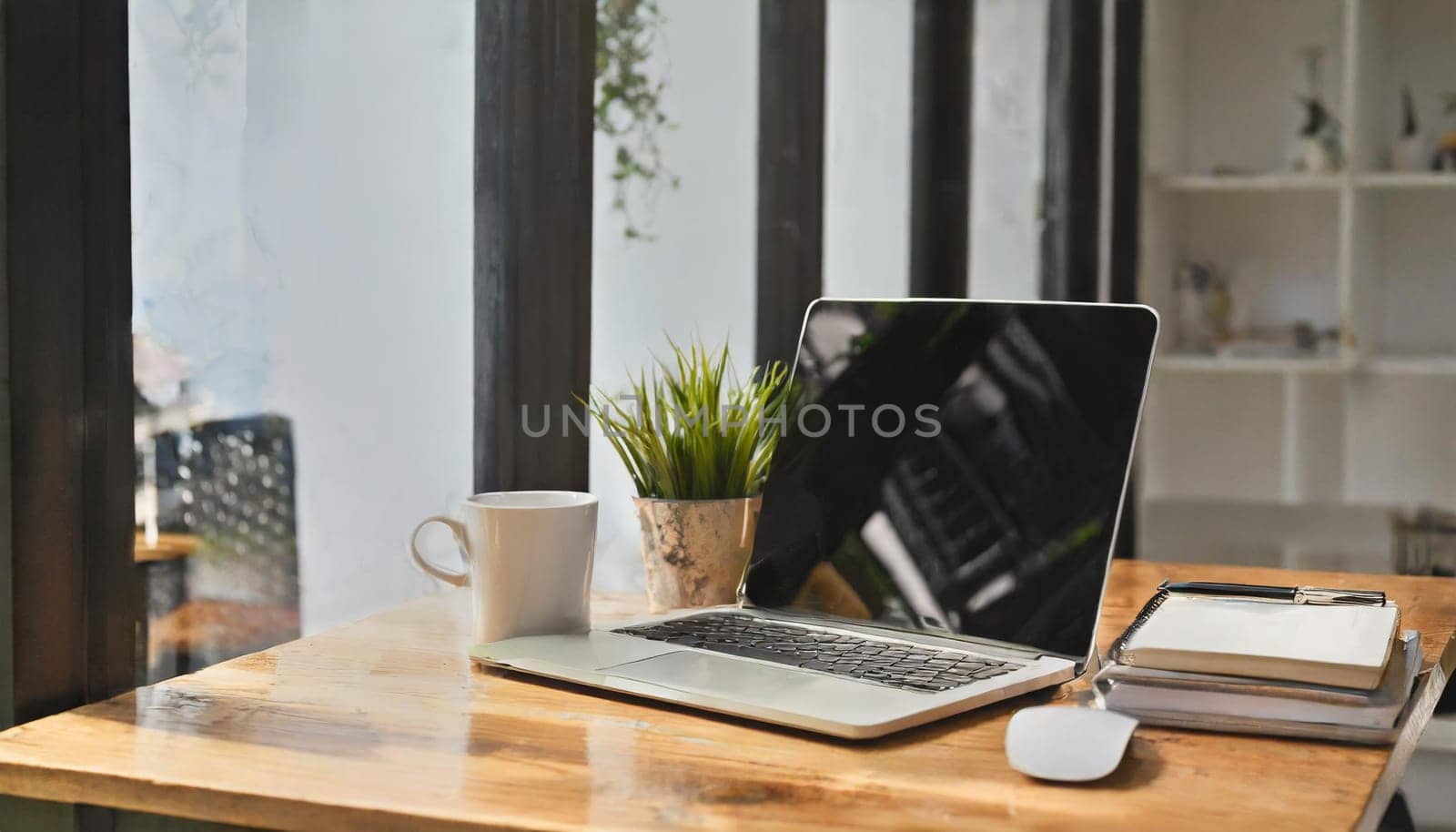 Modern workplace with laptop computer, coffee cup and office supplies