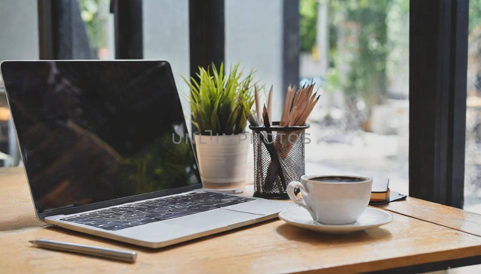 Modern workplace with laptop computer, coffee cup and office supplies