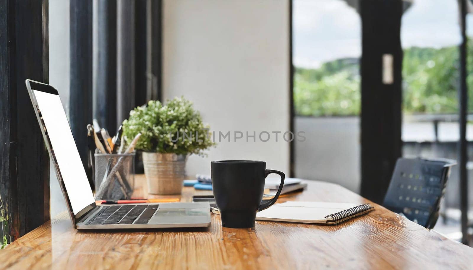 Modern workplace with laptop computer, coffee cup and office supplies