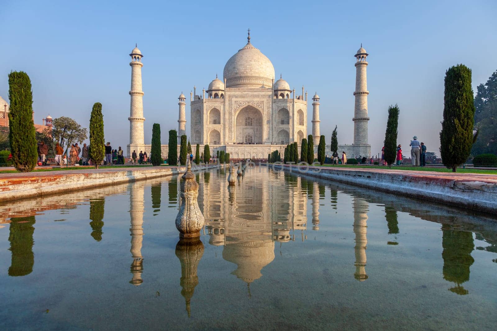 Agra, India - November 15, 2011: people visit Taj Mahal in India with reflection in pond.