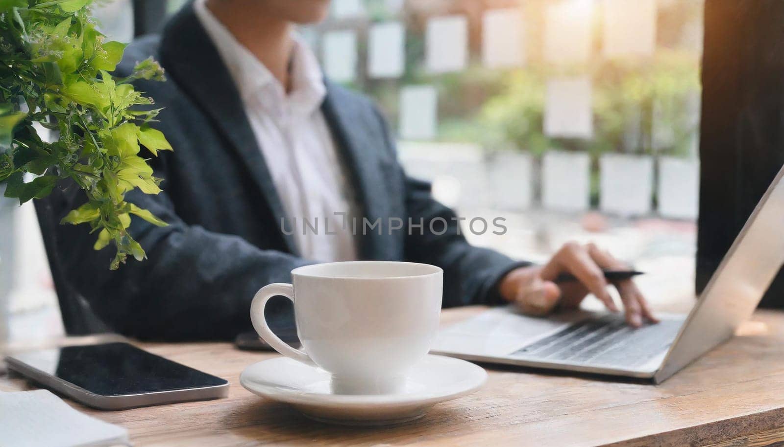 Modern workplace with laptop computer, coffee cup and office supplies