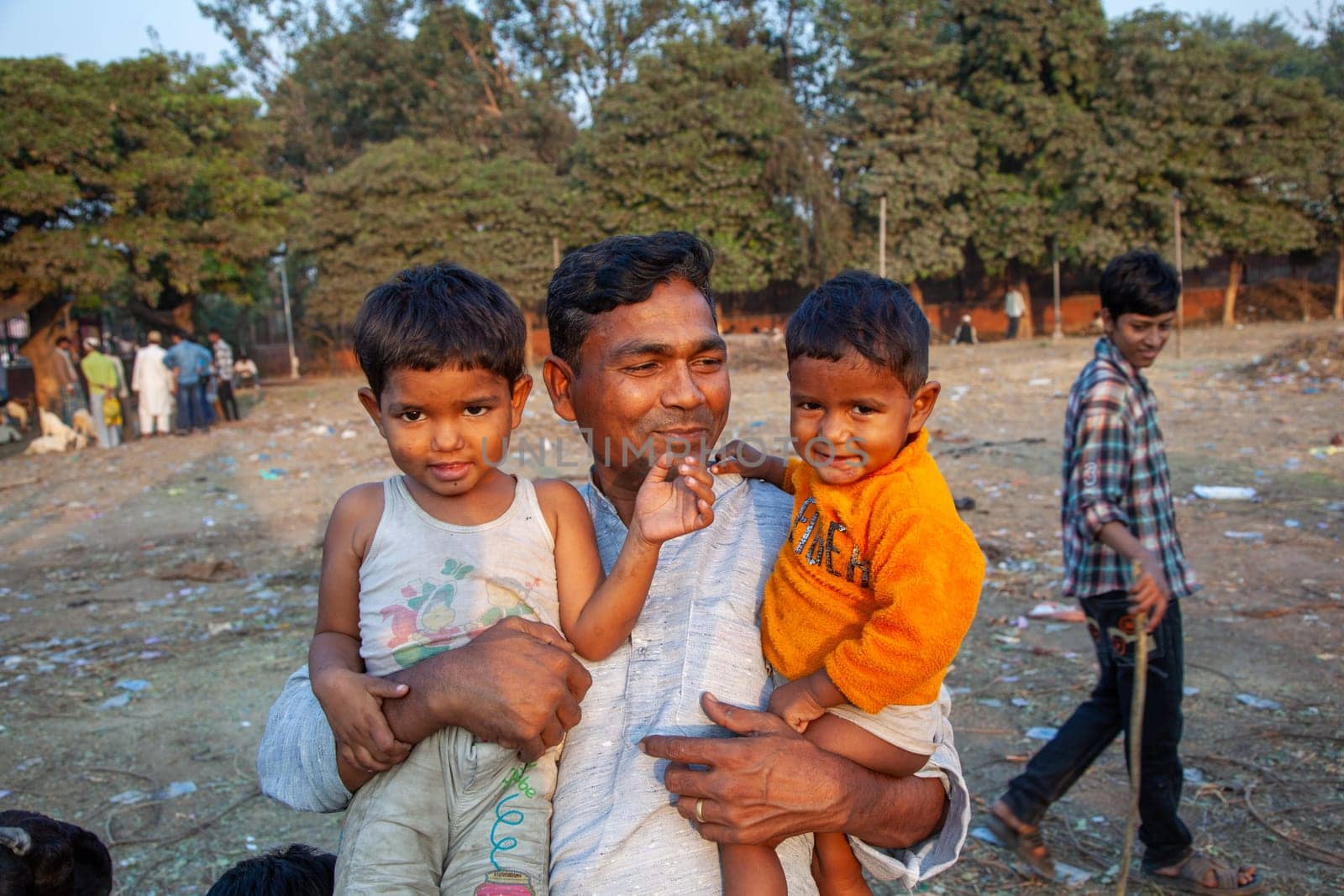 New Delhi, India - November 10, 2011:  proud father poses with his children  Delhi, India. In 1952, India launches  a mass media campaign to spread the concept of family planning to reduce population growth.