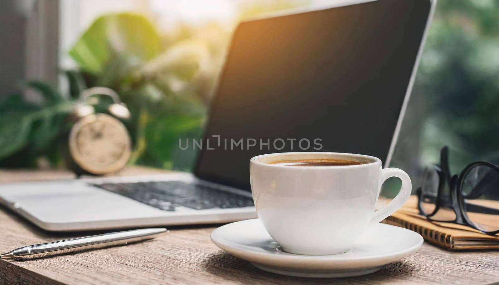 Modern workplace with laptop computer, coffee cup and office supplies