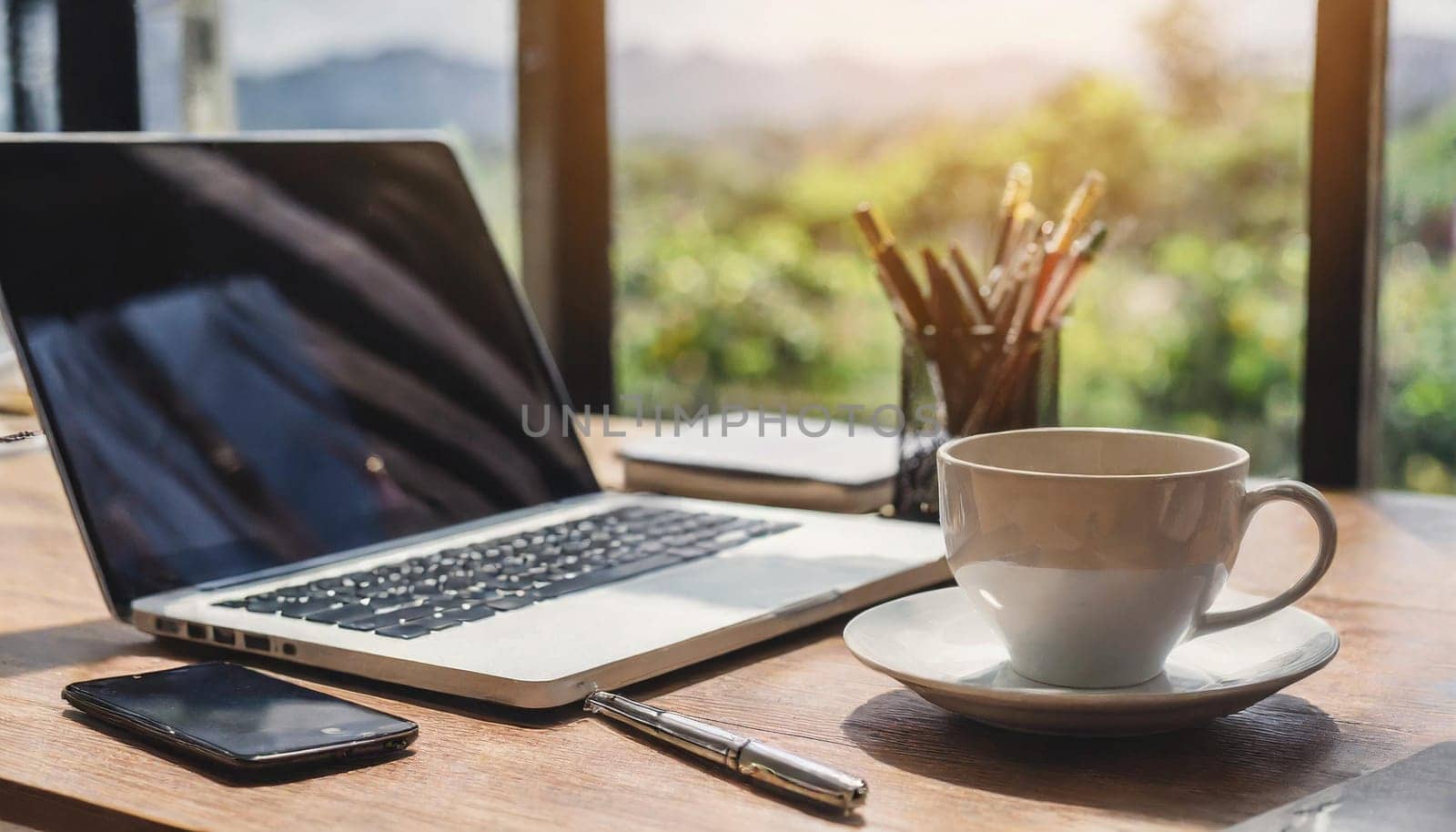 Modern workplace with laptop computer, coffee cup and office supplies