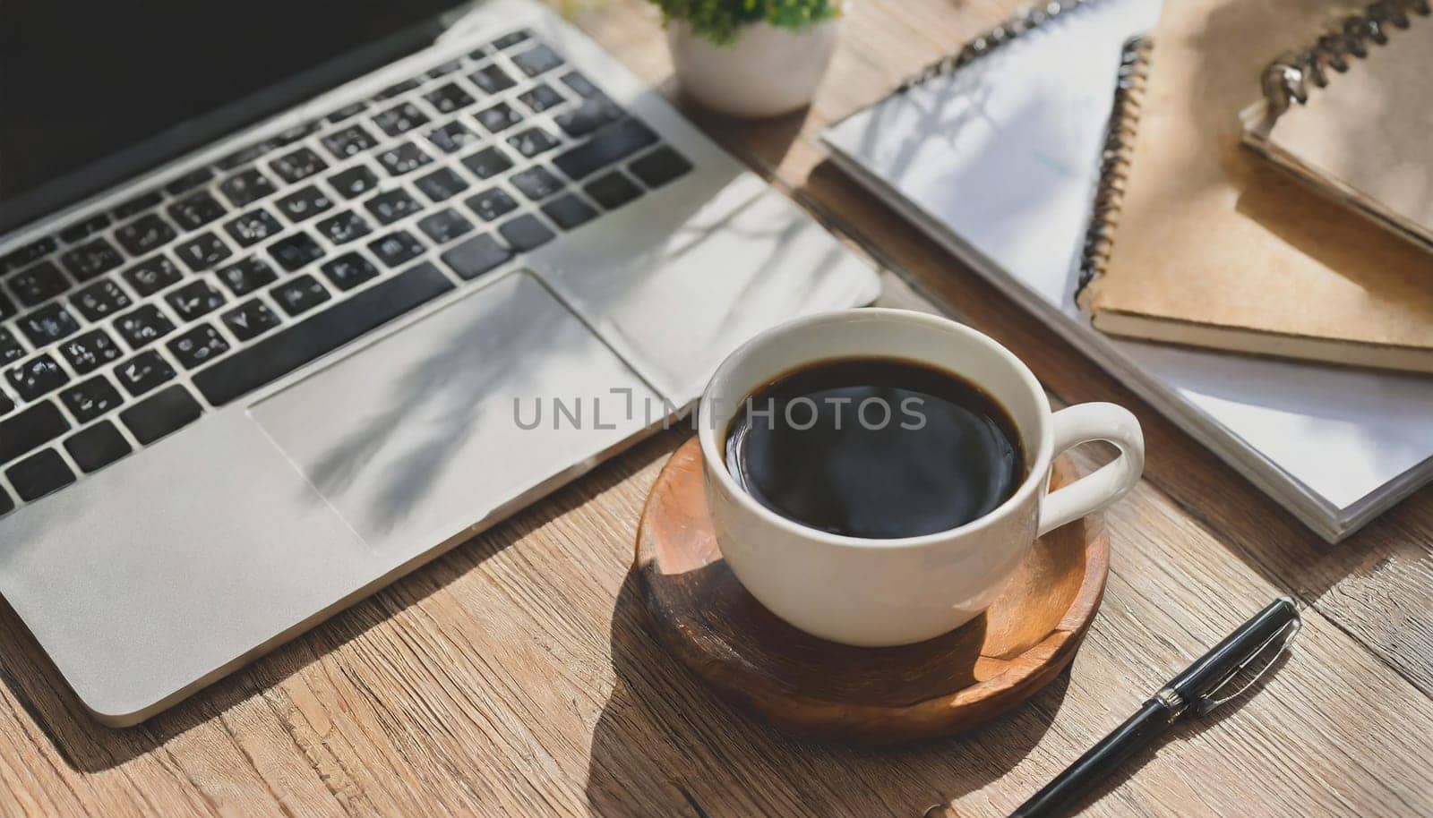 Wood office desk table with a lot of things tablet, laptop ,smartphone ,notepad and coffee cup notepad .copy space virtual interface icons screen.