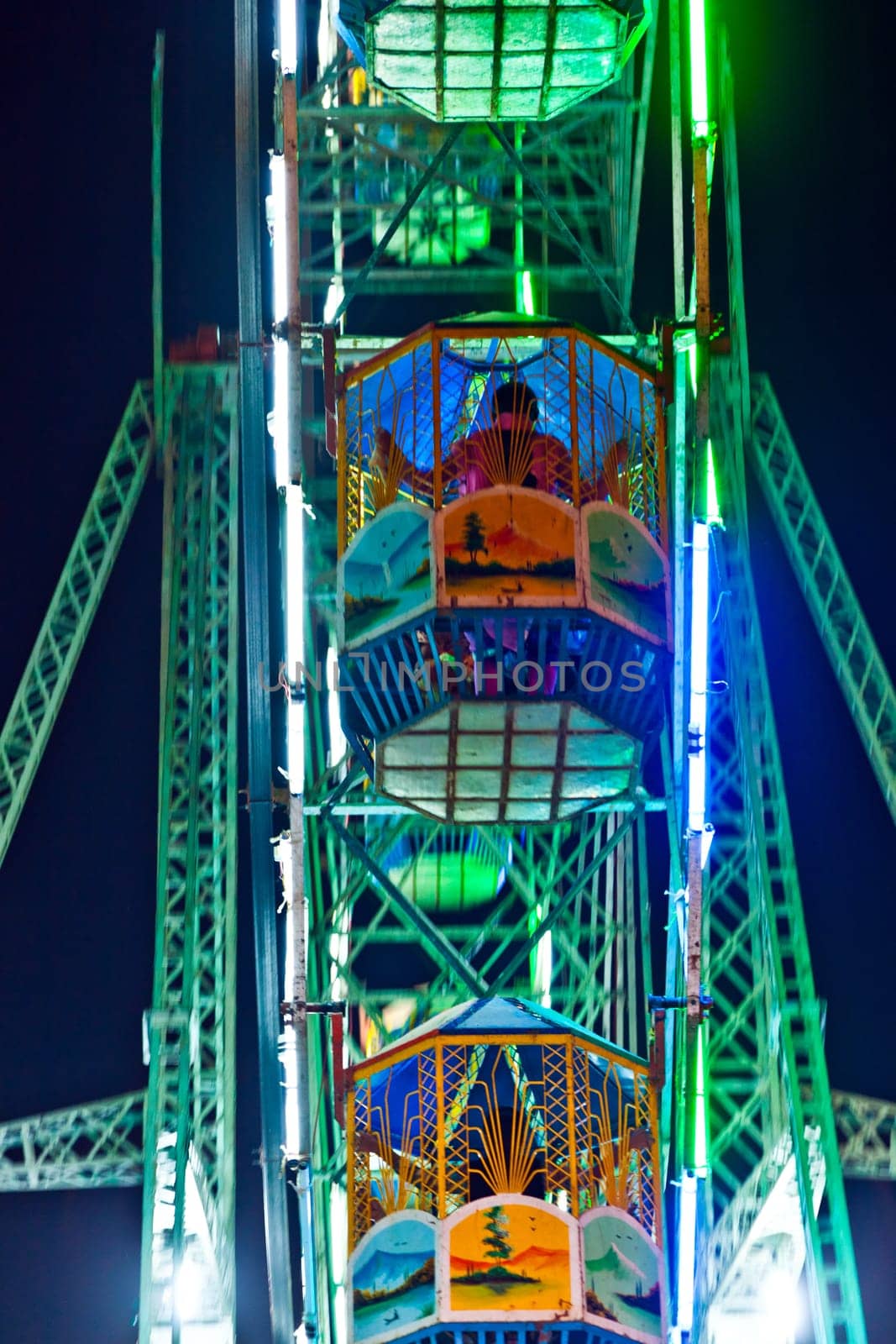 Delhi, India - November 17, 2011: people enjoy the big wheel in the amusement park in Delhi in front of the red fort