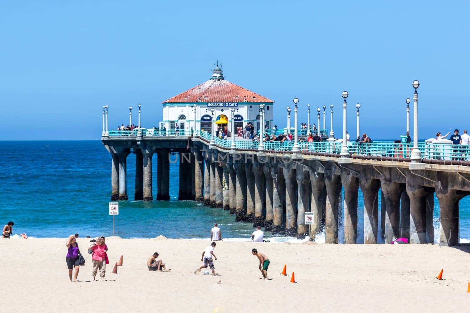 Manhattan Beach, USA - June 24, 2012: people enjoy the beach at the pier in Manhattan Beach, USA.  The famous pier with the octagonal house was completed and dedicated on July 5, 1920.