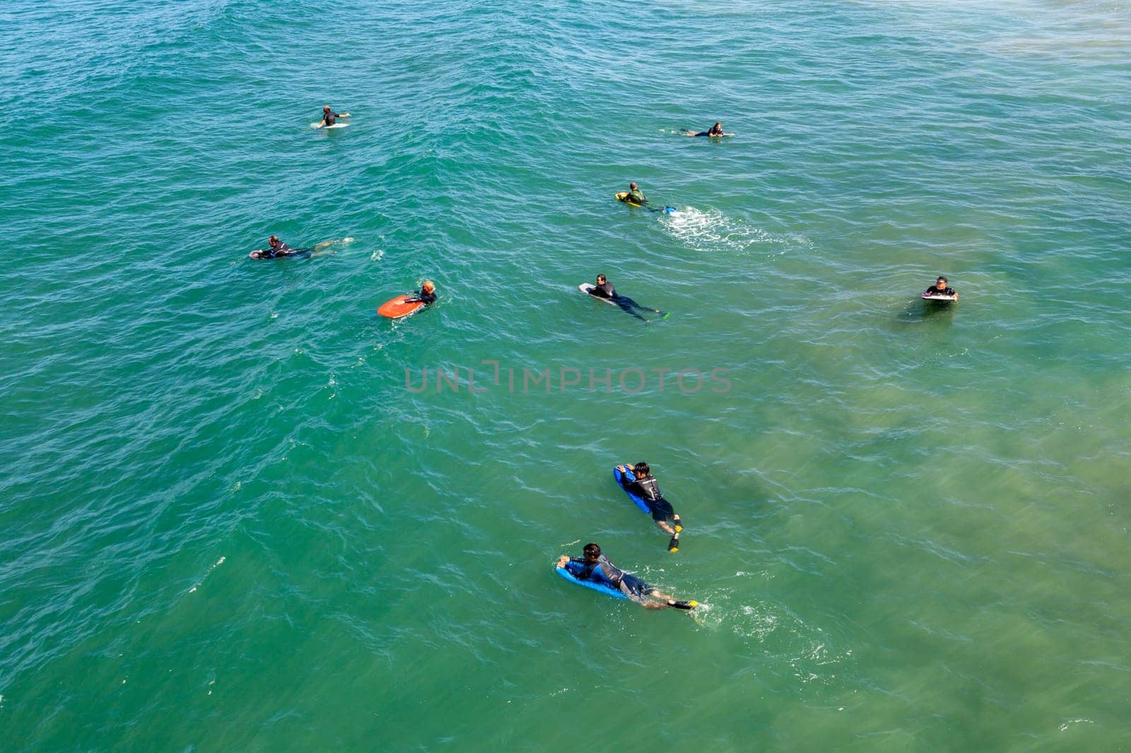 Los Angeles, USA - June 25, 2012: people at Redondo beach wait in the ocean for the next wave for surfing.